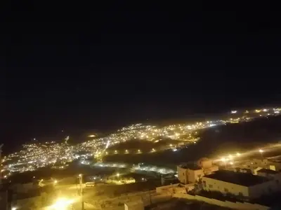 a view of a city at night with lights at Petra Planet in Wadi Musa