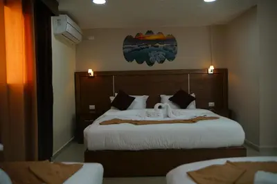 a hotel room with a bed with two swans on it at Petra Aretas Hotel in Wadi Musa