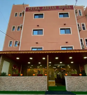a building with a sign on the front of it at Petra Aretas Hotel in Wadi Musa