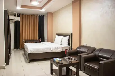 a hotel room with a bed and a couch at Sara Crown Hotel in Irbid