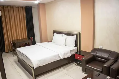 a hotel room with a bed and a chair at Sara Crown Hotel in Irbid