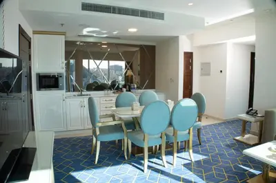 a dining room with blue chairs and a table at Coral Tower Hotel by Hansa in Amman