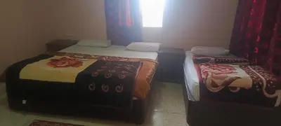 two twin beds in a room with a window at Dana moon Hotel in Dana