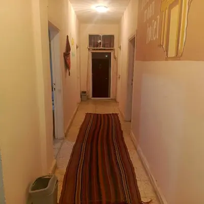 a hallway with a long rug on the floor at Dana moon Hotel in Dana