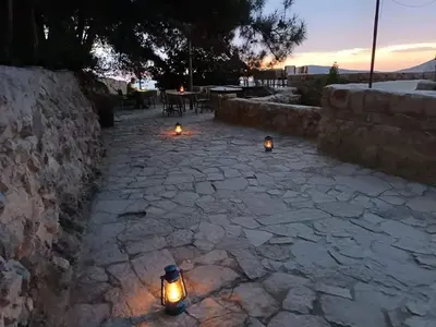a patio with three lights on a stone ground at Dana moon Hotel in Dana