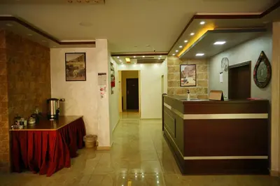 a restaurant with a counter and a bar in a room at Petra Sofsaf Hotel in Wadi Musa