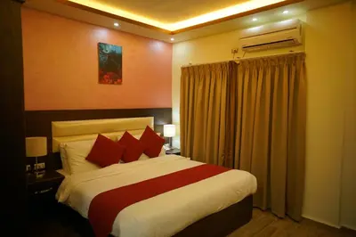 a bedroom with a large bed with red pillows at Petra Sofsaf Hotel in Wadi Musa