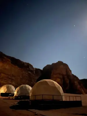 a group of domes in the desert at night at Wadi Rum Nova camp in Wadi Rum