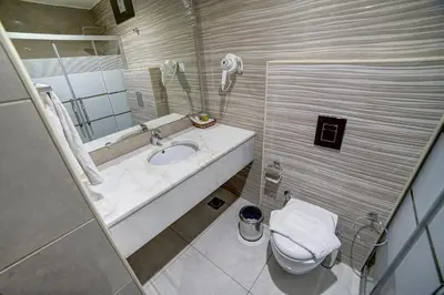 a bathroom with a sink and a toilet at Nairoukh Hotel Aqaba in Aqaba