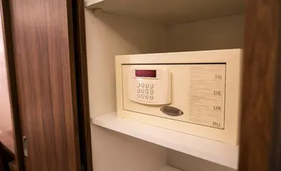 a microwave oven on a shelf in a room at Nairoukh Hotel Aqaba in Aqaba