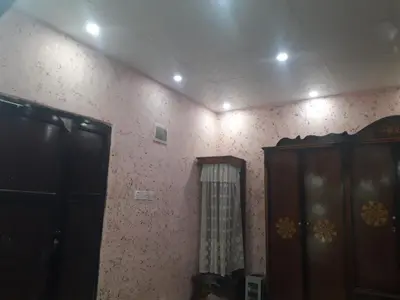 a room with a mirror and a cabinet and a wall at WadiRum Village Lodge in Wadi Rum
