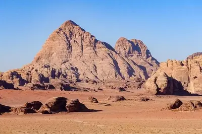 a view of a desert with rocks and a mountain at WadiRum Mobile Camp in Wadi Rum