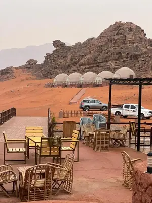 a group of tables and chairs in the desert at sand magic camp in Wadi Rum