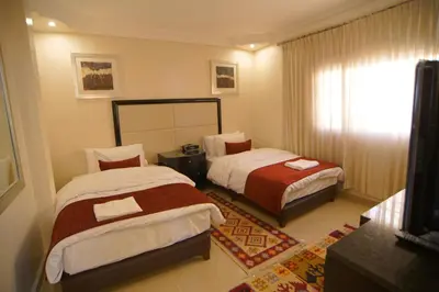 a hotel room with two beds and a window at Over Mountains Hotel in Wadi Musa