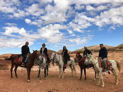a group of people riding horses in the desert at Ammarin Bedouin Camp in Wadi Musa