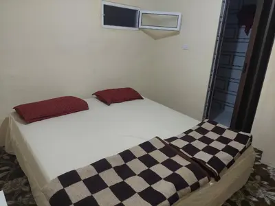 a bed with two pillows on it in a room at Wadi Ghwere Camp مخيم وادي الغوير in Al Khuraybah