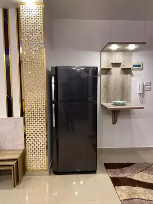 a kitchen with a black refrigerator in a room at شركة مسايا لشقق المفروشة in Irbid