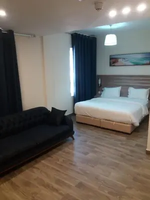 a bedroom with a bed and a couch in it at La Riva Hotel in Aqaba