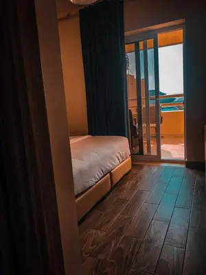a bedroom with a bed and a sliding glass door at La Riva Hotel in Aqaba