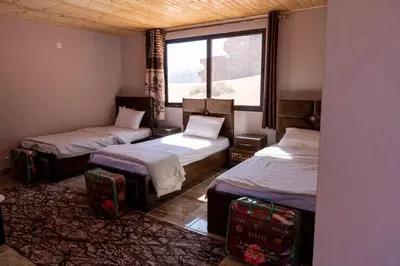 a room with two beds and a window at Wadi Rum Quiet Sky in Wadi Rum