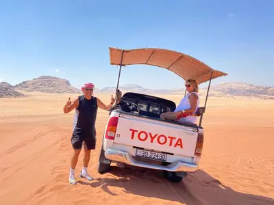 a man and a woman standing in the desert at Wadi Rum Quiet Sky in Wadi Rum
