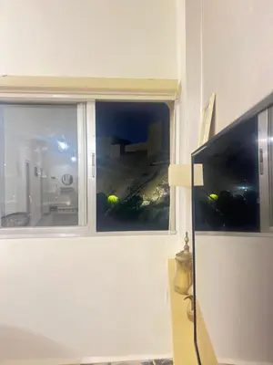 a window in a room with a view of a building at the old house in Kerak