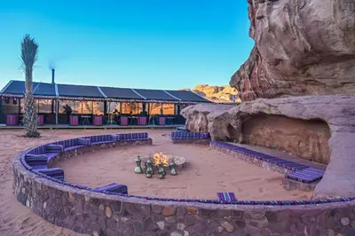a group of people standing in front of a building at Palmera Camp Wadi Rum in Wadi Rum