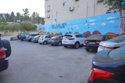 a bunch of cars parked in a parking lot at Petra Plaza Hotel in Wadi Musa