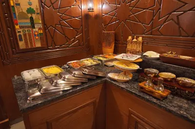 a buffet with many different types of food on a counter at Petra Plaza Hotel in Wadi Musa