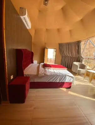 a bedroom with a bed in a tent at Wadi Rum Mars Camp in Wadi Rum