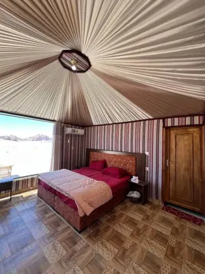 a bedroom with a large bed in a tent at Wadi Rum Mars Camp in Wadi Rum