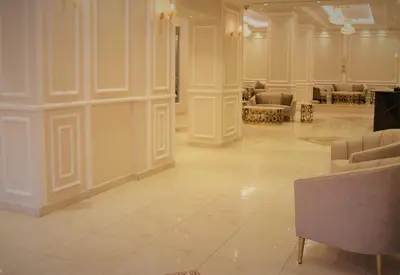 a large room with a lobby with chairs and tables at New MerryLand Hotel in Amman