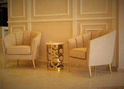 two chairs and a table in a room at New MerryLand Hotel in Amman