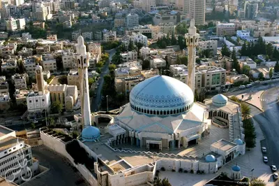 a mosque with a blue dome and minarets in a city at New MerryLand Hotel in Amman