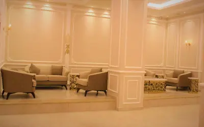 a room with couches and chairs in a building at New MerryLand Hotel in Amman