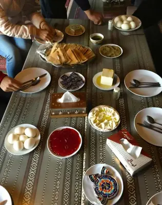 a table topped with plates and bowls of food at One Thousand and One Nights Camp in Wadi Rum
