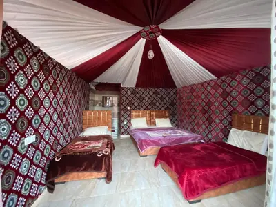 a room with two beds in a tent at Rum Panoramic Camp & Tour in Wadi Rum