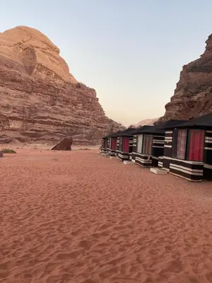 a row of buildings in the desert with a mountain at Rum Panoramic Camp & Tour in Wadi Rum