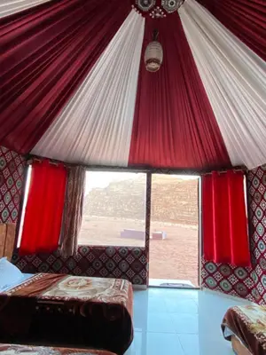 a room with a bed and a large window at Rum Panoramic Camp & Tour in Wadi Rum