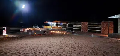 a beach at night with a street light at Real Bedouin life &tour in Wadi Rum