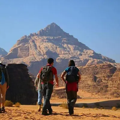 a group of people walking through the desert at WADI RUM STAR WARS CAMP in Wadi Rum