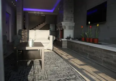 a living room with a white couch and a table at Dar Gerasa chalets - شاليهات دار جراسا in Jerash