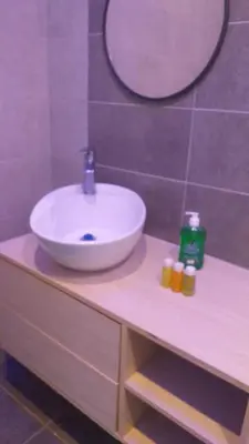a bathroom with a white sink on a counter at Dar Gerasa chalets - شاليهات دار جراسا in Jerash