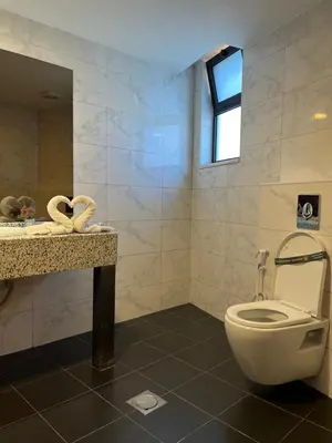 a bathroom with a toilet and a sink at Strand Hotel Jordan in Amman