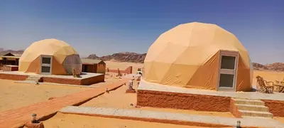 a group of domes in a desert at Wadi Rum Maracanã camp in Wadi Rum