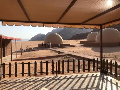 a view of a desert with domes and a fence at Wadi Rum Maracanã camp in Wadi Rum