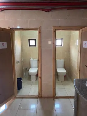 a bathroom with two toilets and two sinks at Wadirum momoo in Wadi Rum