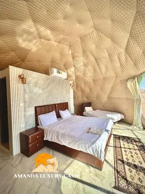 a bedroom with a large bed with a wooden ceiling at Amanda Luxury Camp in Wadi Rum