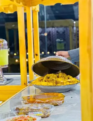 a table with two pans of food on a table at WADI RUM TARA lUXURY CAMP in Wadi Rum