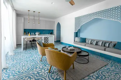 a living room with a couch and a table and chairs at Cloud 7 Residence Ayla Aqaba in Aqaba